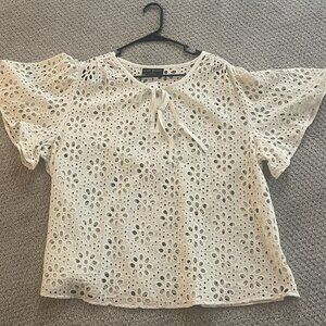 Cute, cream blouse with floral cut-outs by Lane Bryant